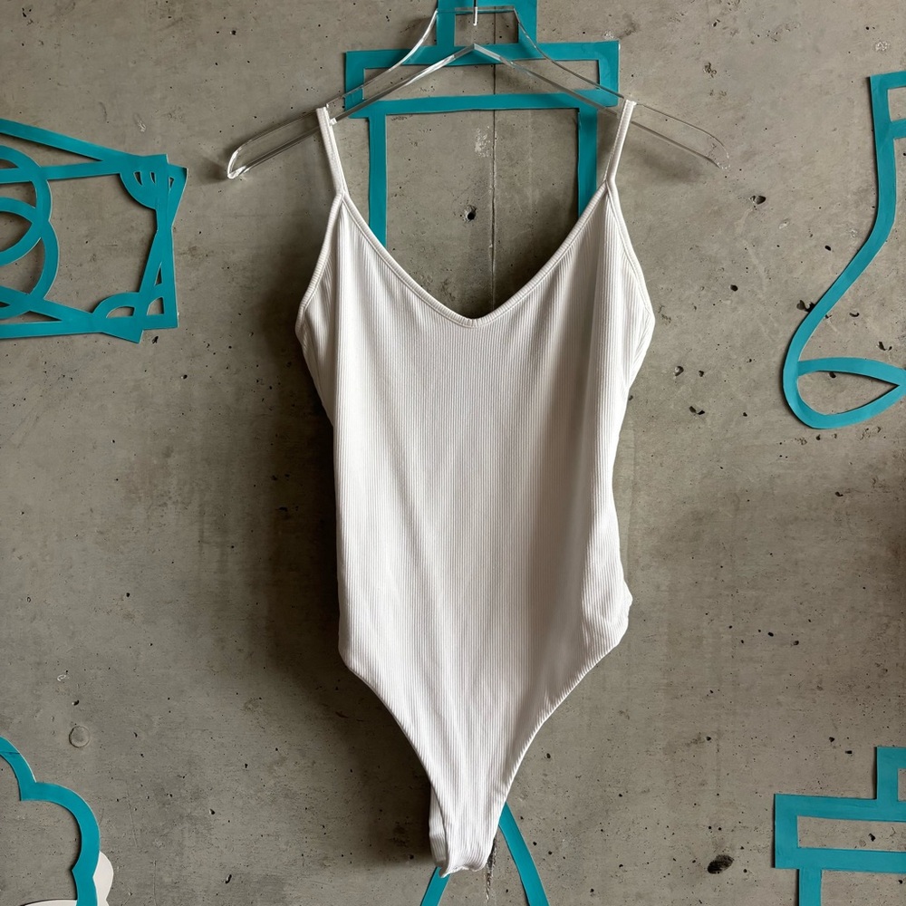 Naked Wardrobe Ribbed V Neck Spaghetti Strap Thong Bodysuit